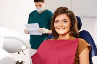 a woman smiles in the dental chair | periodontal treatment Humble, TX