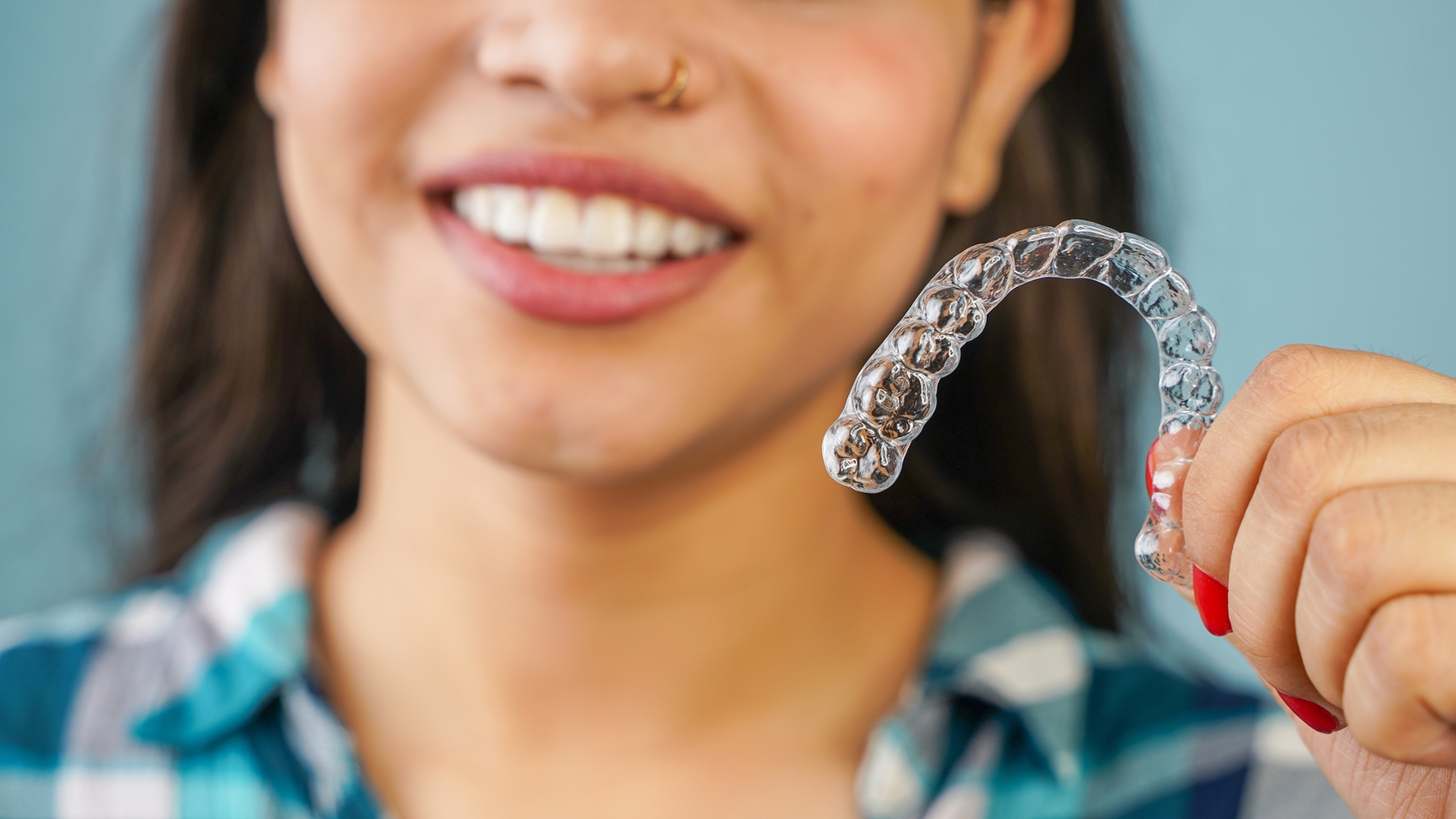 patient holding a clear plastic aligner in humble tx