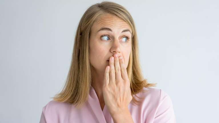 woman thinking about tooth replacement options in Humble, TX
