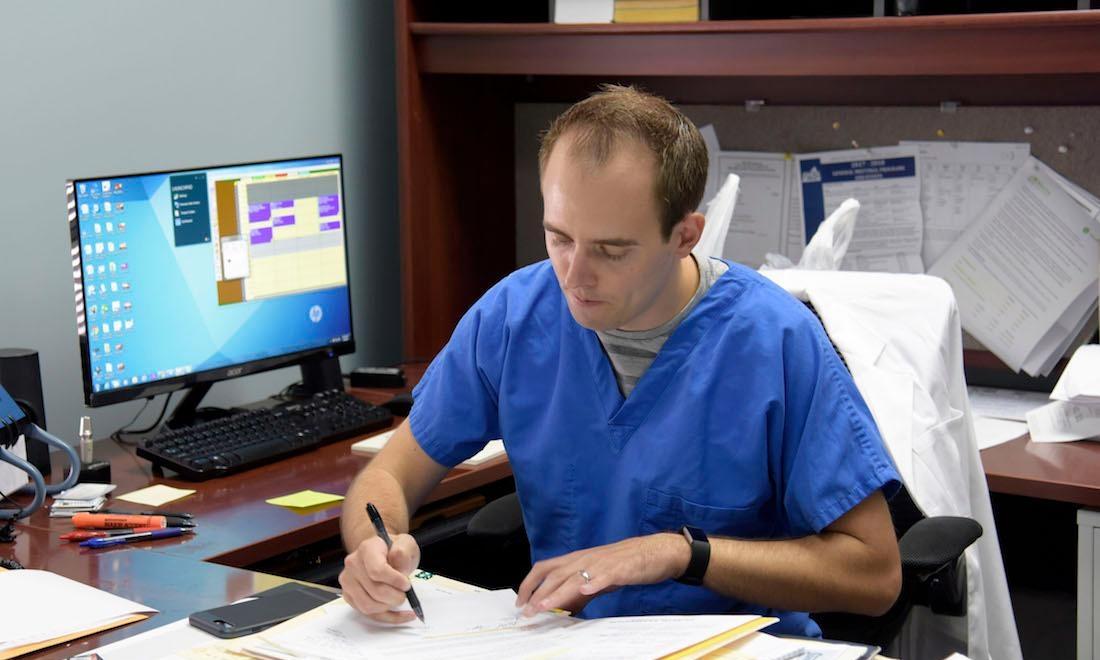 dr. robert appel working on some forms | dentist in humble tx