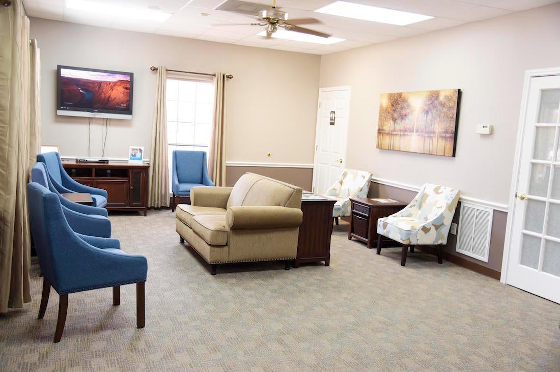 our front-office reception area, featuring a couch, and arm chairs | dentist in humble tx